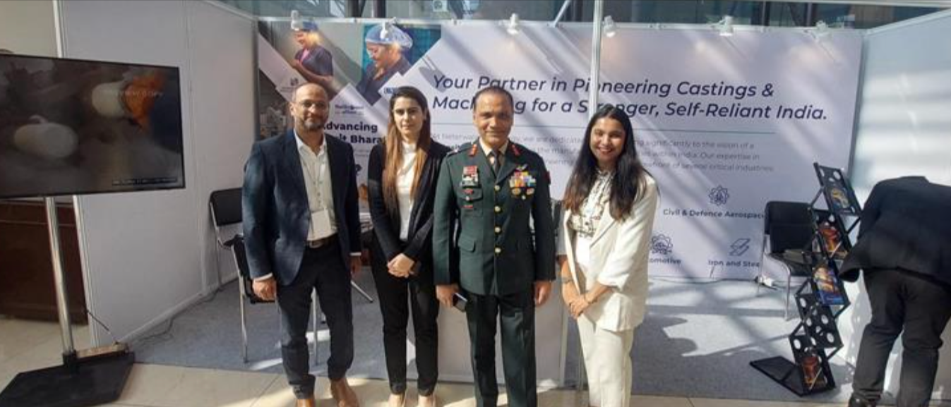 Neterwala Group team members stand with defence officials in front of their booth, highlighting engi